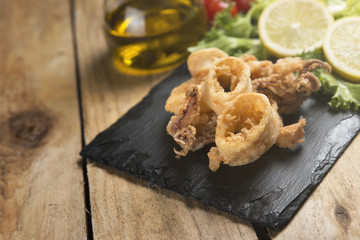 fried crispy calamari served on slate plate