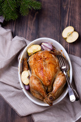 roasted chicken on wooden table, top view