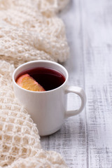 Obraz na płótnie Canvas Mulled wine in white porcelain mug with spices and citrus fruit