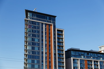 Modern office building with blue glass facade futuristic.