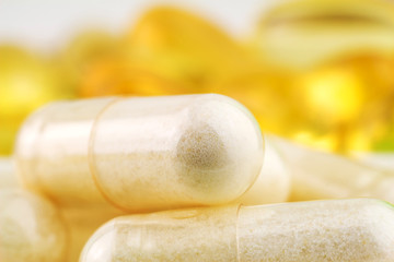 Natural food supplement pills, glucosamine and omega 3 capsules, macro image.