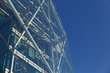 Modern office building with blue glass facade futuristic.