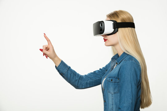 Attractive woman wearing virtual reality goggles. VR headset. Virtual reality concept on white background.