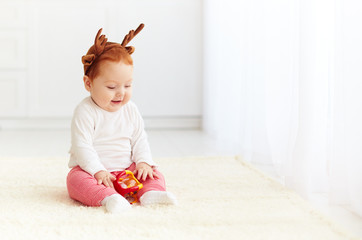 Fototapeta premium happy baby deer playing with toy at home