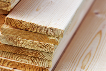 Pile of new wooden boards on a storage