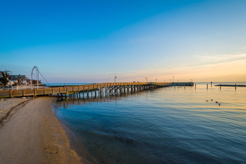 Fototapeta na wymiar Fishing pier and the Chesapeake Bay at sunrise, in North Beach,