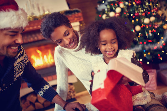 Happy smiling African American family in Christmas atmosphere