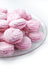 marshmallow - zephyr with coconut flakes on a white background.