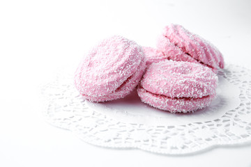 marshmallow - zephyr with coconut flakes on a white background.