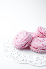 marshmallow - zephyr with coconut flakes on a white background.