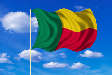 Flag of Benin waving on blue sky background