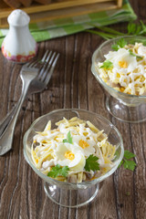 Festive salad with pickled herring, cheese and egg. Appetizer on