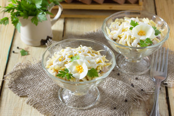 Salad with pickled herring, cheese and egg. Appetizer on a festi