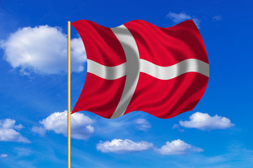 Flag of Denmark waving on blue sky background