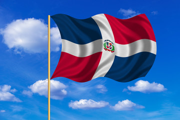 Dominican Republic flag on flagpole wavy, blue sky