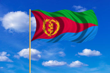 Flag of Eritrea waving on blue sky background