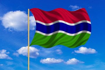 Flag of the Gambia waving on blue sky background
