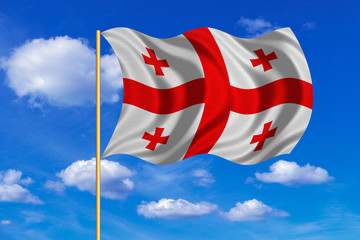 Flag of Georgia waving on blue sky background