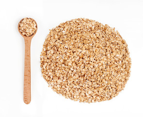 Wooden spoon and pile of oats on white background. Healthy food. Close up, top view, high resolution product.