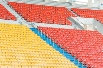 Empty orange and yellow seats at stadium,Rows of seat on a soccer stadium