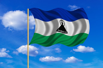 Flag of Lesotho waving on blue sky background