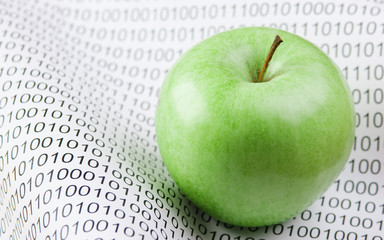 green apple on a binary code