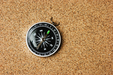 Fototapeta na wymiar compass on a sandy beach