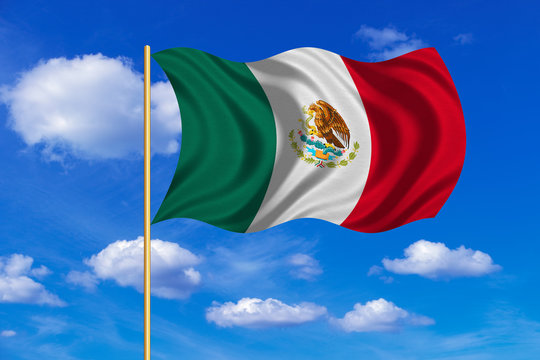 Flag of Mexico waving on blue sky background