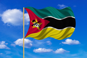 Flag of Mozambique waving on blue sky background