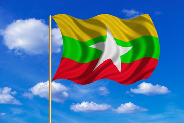 Flag of Myanmar waving on blue sky background