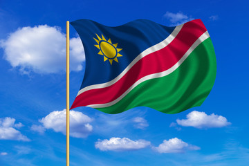 Flag of Namibia waving on blue sky background
