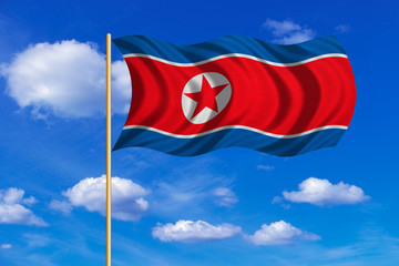 Flag of North Korea waving on blue sky background