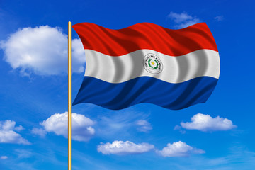 Flag of Paraguay waving on blue sky background