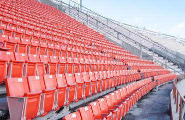Fototapeta premium Empty orange seats at stadium,Rows of seat on a soccer stadium