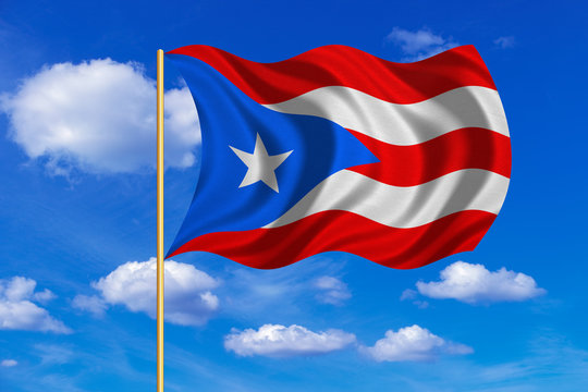 Flag of Puerto Rico waving on blue sky background