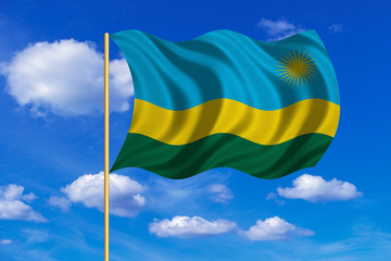 Flag of Rwanda waving on blue sky background