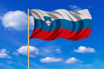 Flag of Slovenia waving on blue sky background