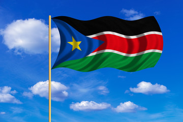 Flag of South Sudan waving on blue sky background