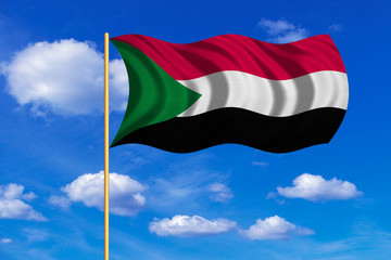 Flag of Sudan waving on blue sky background