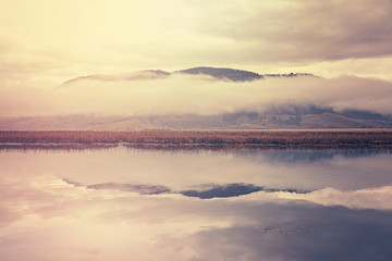 Obraz premium Retro toned foggy morning over lake in Grand Teton National Park, Wyoming, USA.