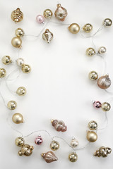 Pink and Gold Vintage Christmas Ornaments and Antique Mercury Glass String Lights Flat lay composition for bloggers, magazines, social media and artists. Top view.