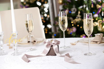 Christmas gifts on the beautiful table with Christmas tree on ba