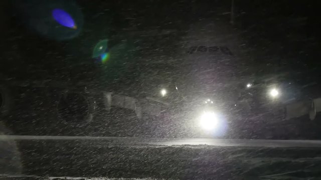 Airliner turns on the runway. At night, in the winter.