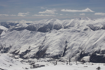 Fototapeta na wymiar Mountain peaks in the snow. View of the mountain on the horizon.