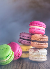 Colorful macarons on the wooden background