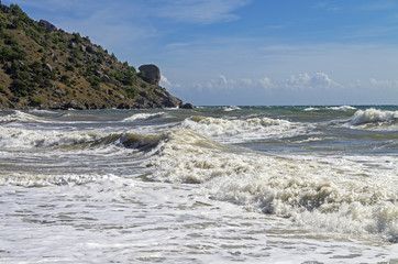 Fototapeta na wymiar White foam in the strong surf. Crimea.