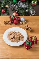 The white plate of the gingerbread man on the wooden table and C