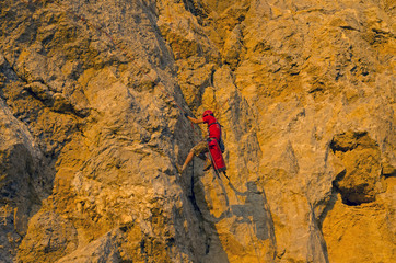 Rock climber on a steep rock.