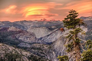 Lenticular clouds during fiery sunset over Half Dome in Yosemite National Park
