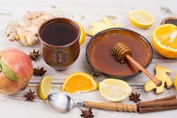 Natural flu and cold remedy - orange and lemon fruit, fresh ginger, honey